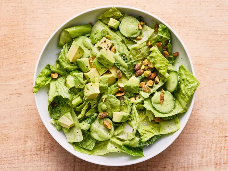 overhead view on a salad topped with green goddess dressing